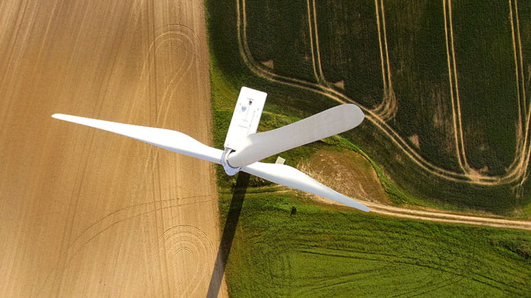 Aerial view of a wind turbine in an agricultural field